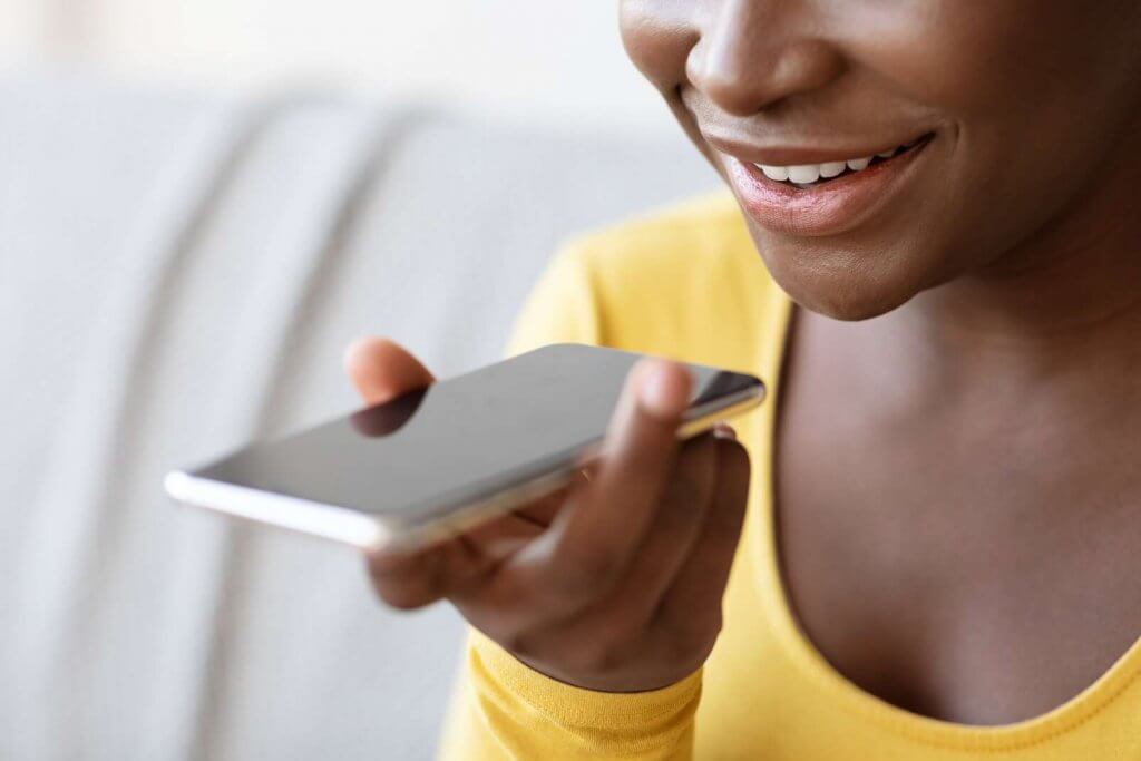 black-woman-using-voice-assistant-option-on-smartphone