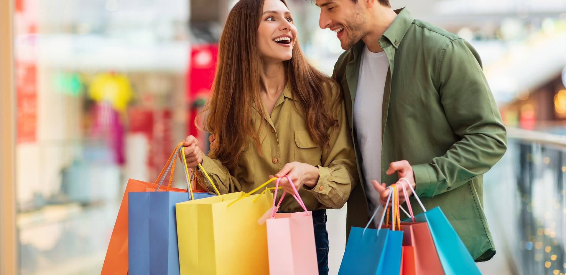 joyful-couple-on-shopping-laughing-holding-shopper
